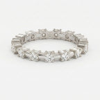Side profile of diamond eternity wedding band showing elevated shared-prong setting and polished gold finish.