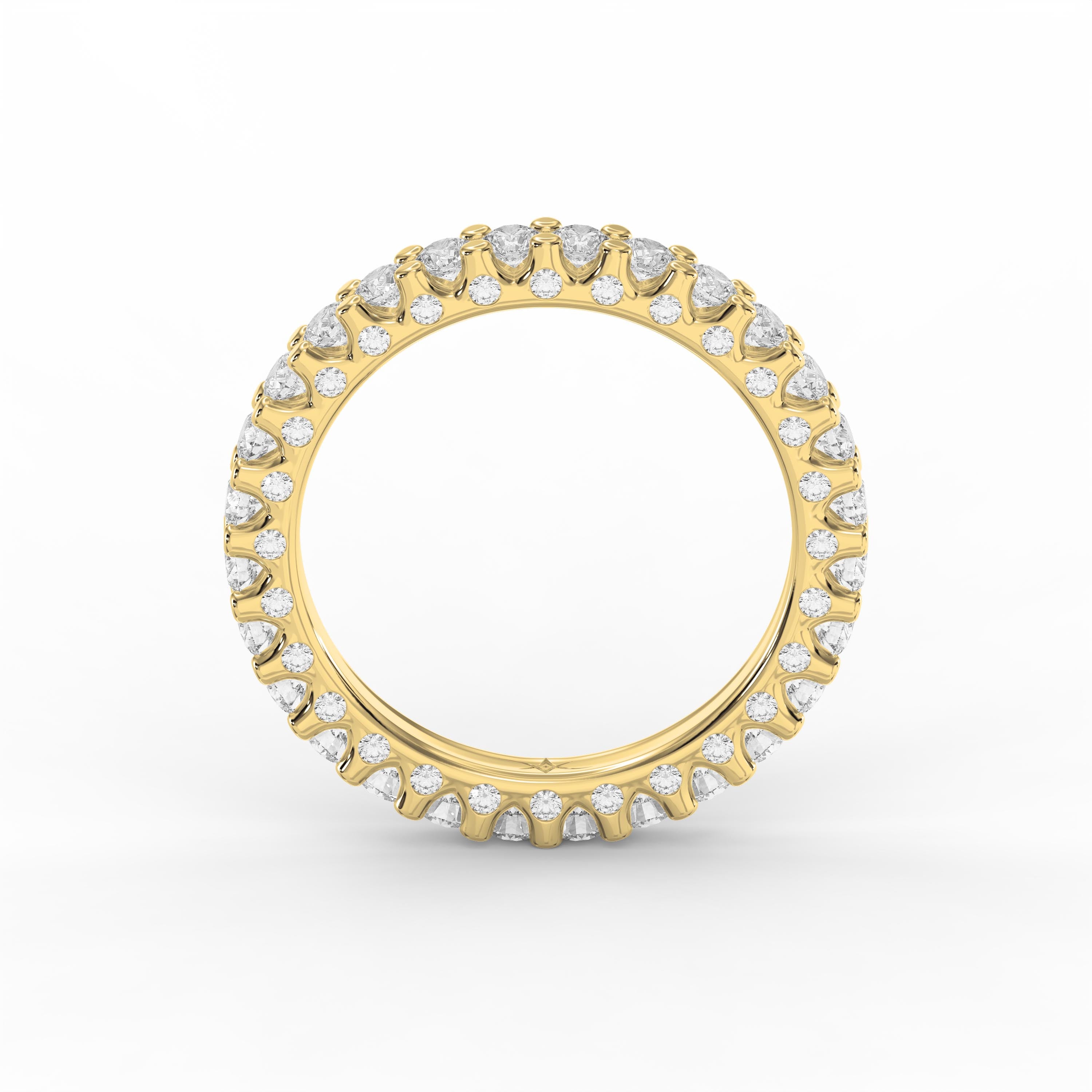 Yellow gold diamond eternity band featuring round brilliant diamonds in a shared prong setting for weddings and stacking.