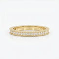 Yellow gold diamond eternity band with round brilliant diamonds and milgrain detailing on a clean white background