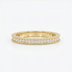 Yellow gold diamond eternity band with round brilliant diamonds and milgrain detailing on a clean white background