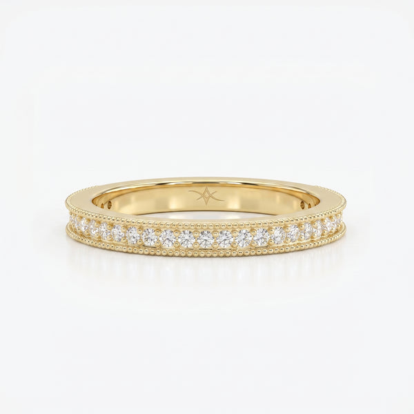 Yellow gold diamond eternity band with round brilliant diamonds and milgrain detailing on a clean white background