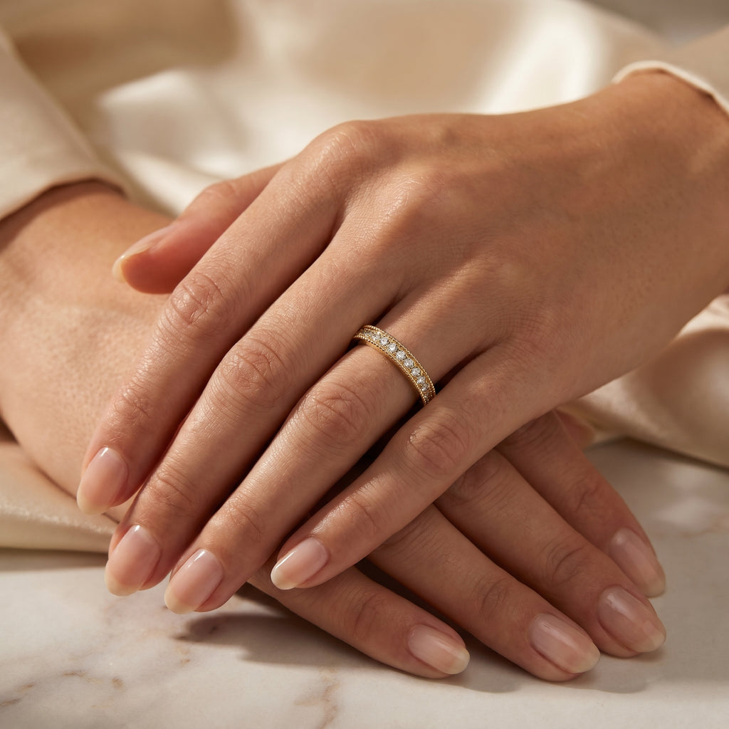 Woman wearing yellow gold diamond eternity band showcasing elegant stackable fine jewelry styling