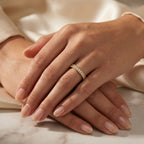 Woman wearing yellow gold diamond eternity band showcasing elegant stackable fine jewelry styling