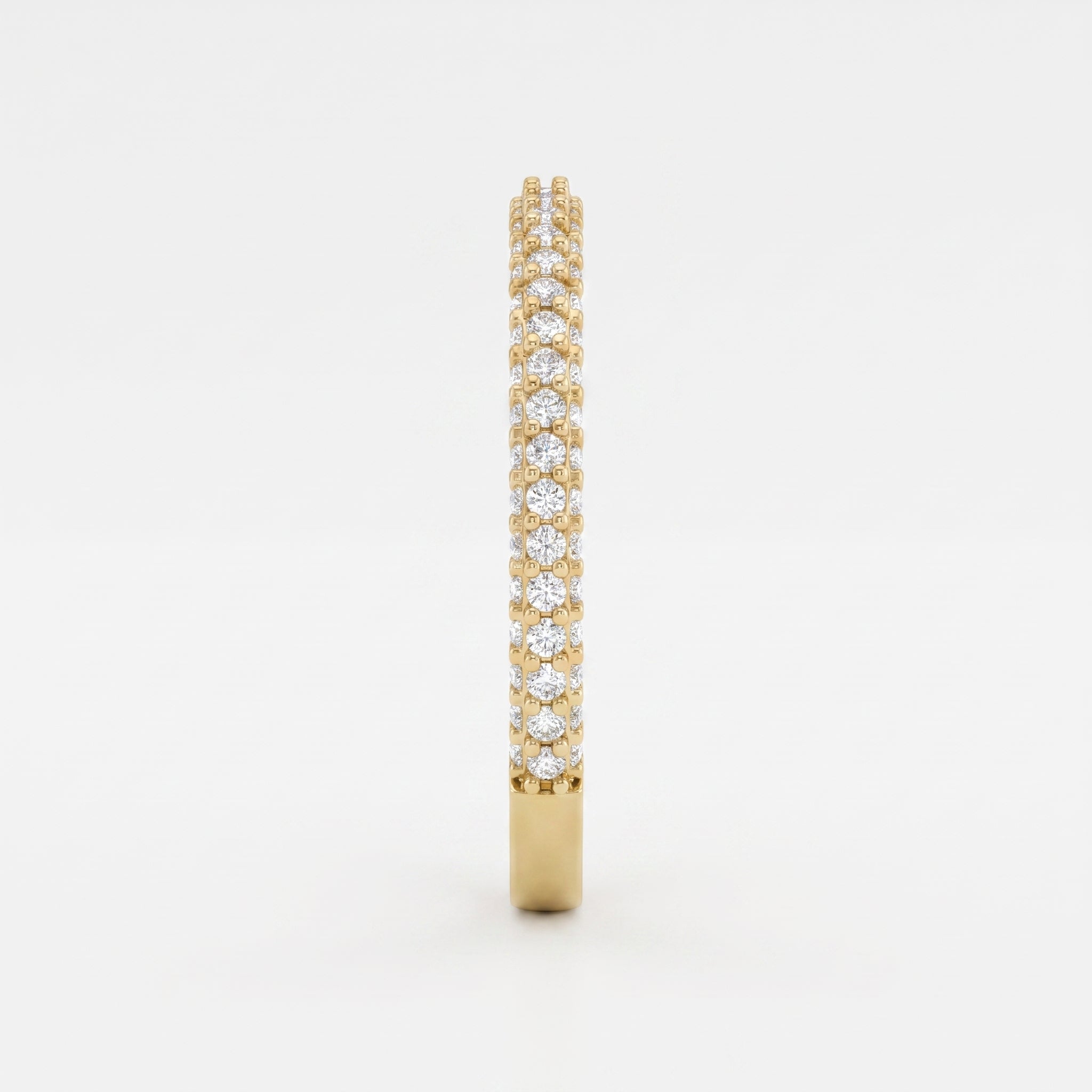 Side profile of a yellow gold eternity ring highlighting round brilliant diamonds and elegant shared prong craftsmanship.