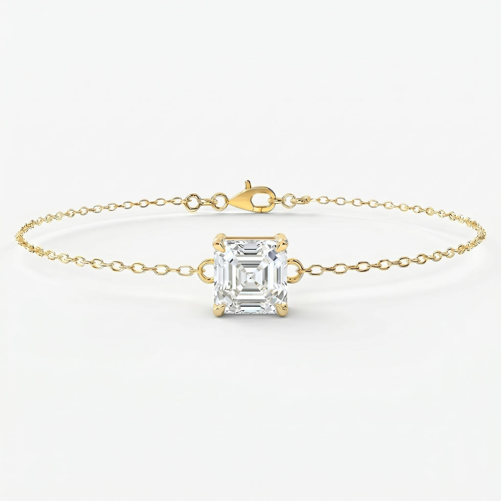 Minimalist yellow gold bracelet with Asscher-cut solitaire gemstone on delicate chain studio front view