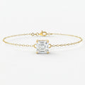 Minimalist yellow gold bracelet with Asscher-cut solitaire gemstone on delicate chain studio front view
