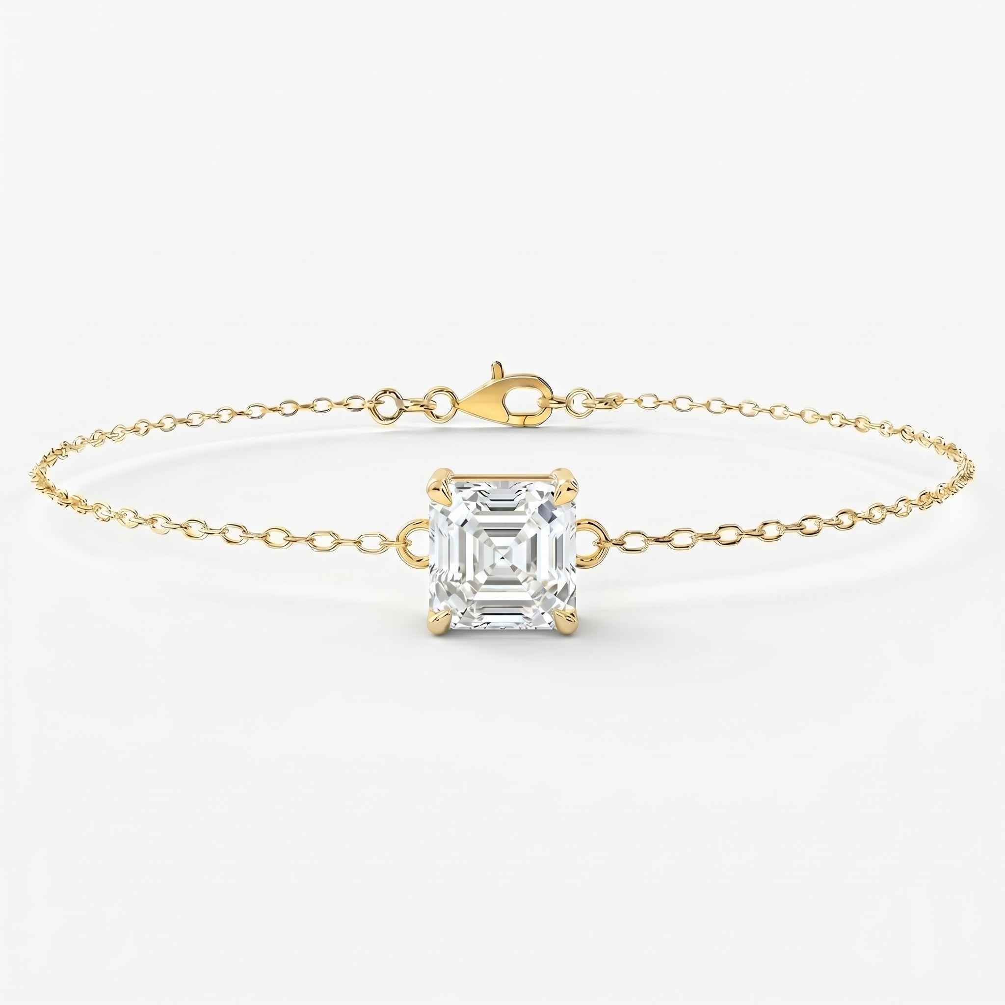 Minimalist yellow gold bracelet with Asscher-cut solitaire gemstone on delicate chain studio front view