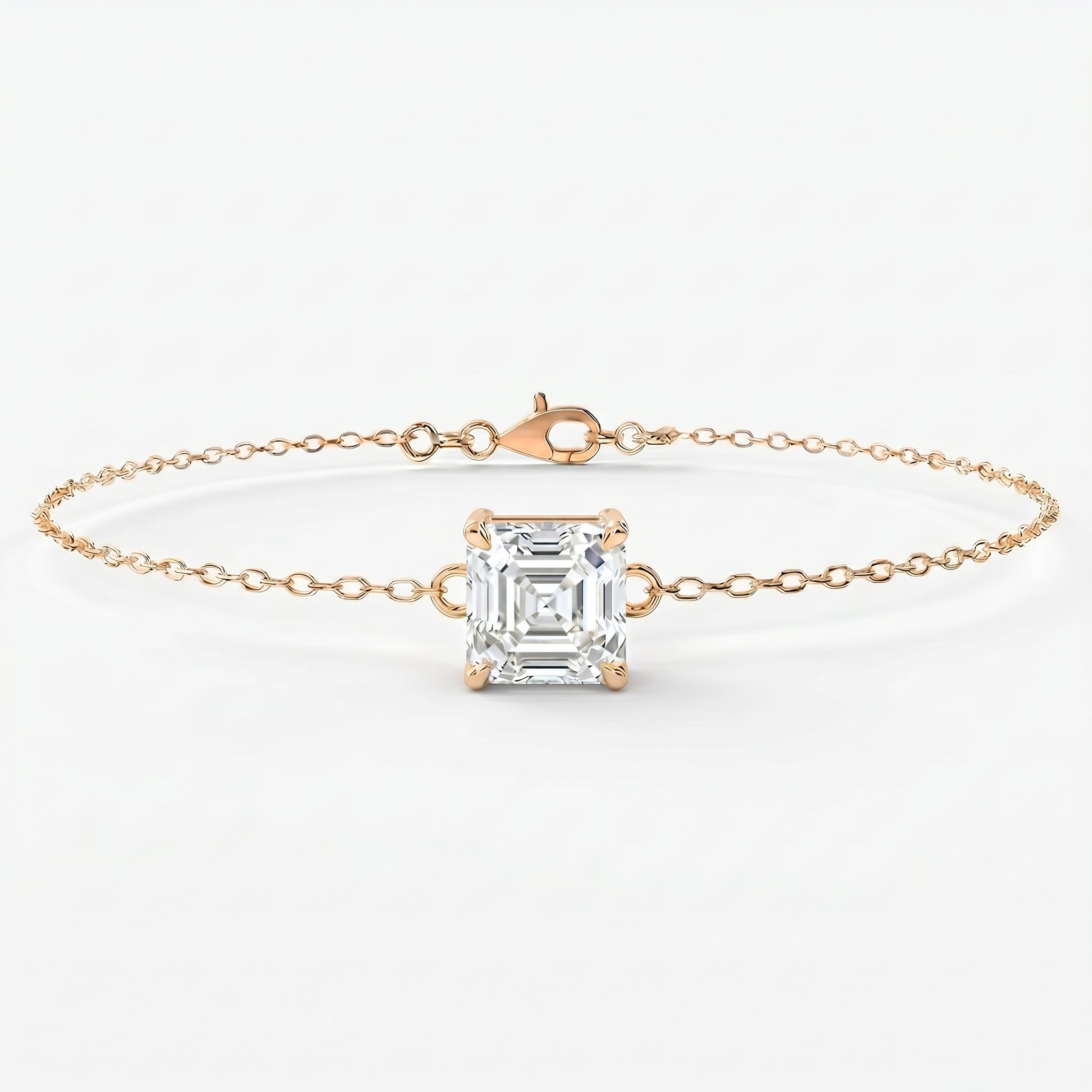 Minimalist asscher cut solitaire bracelet in yellow gold with delicate chain and sparkling diamond centerpiece