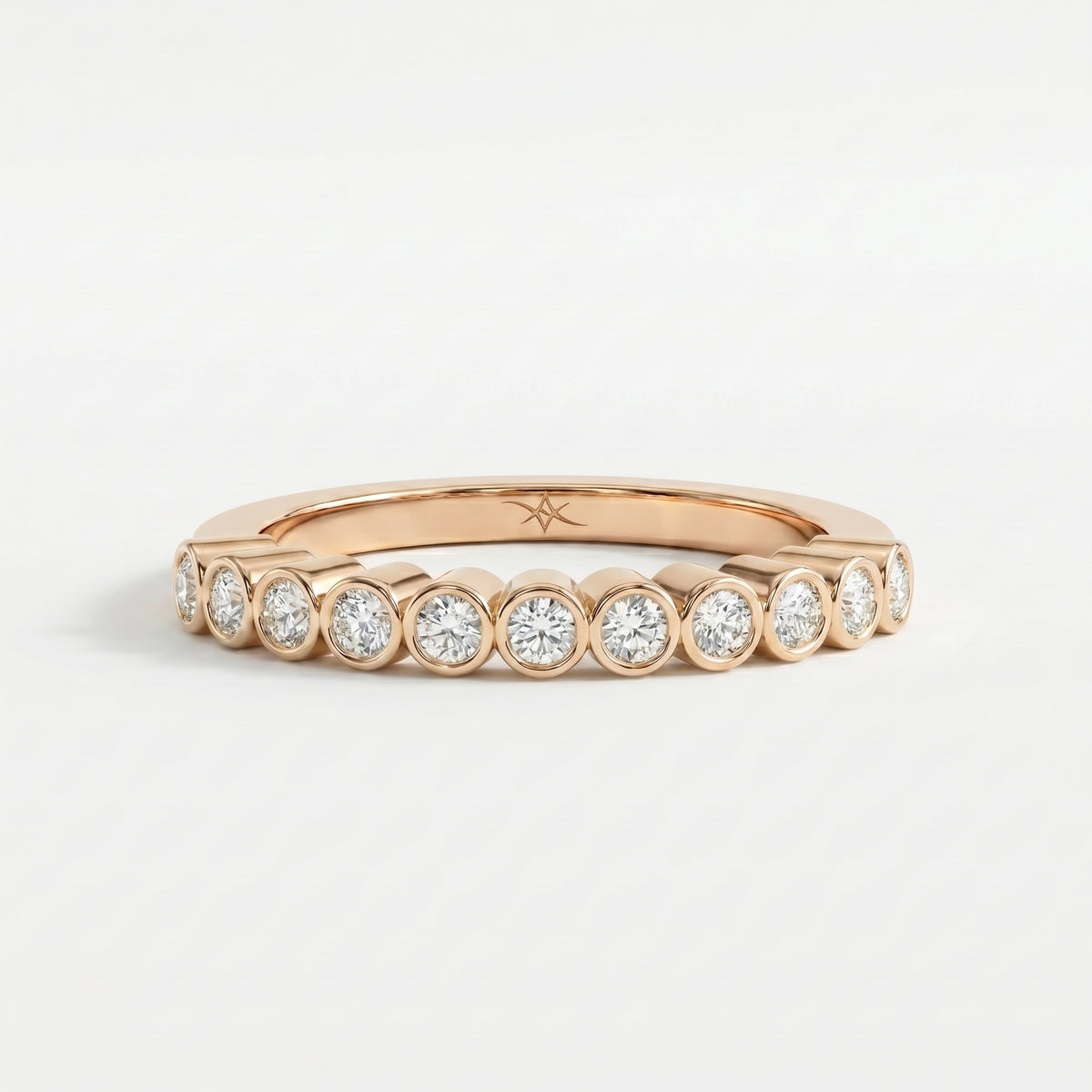 Curved diamond wedding band shown in  rose gold  