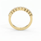 Curved yellow gold diamond wedding band with bezel-set round diamonds, minimalist luxury stacking ring design