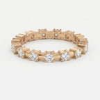 Rose gold eternity ring with round brilliant diamonds shown at 45-degree angle highlighting craftsmanship and sparkle.