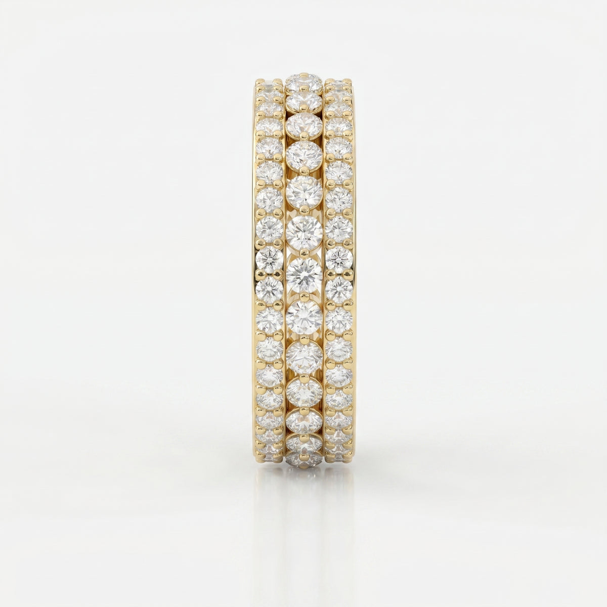 Side view of yellow gold diamond eternity band showing open gallery design and secure diamond setting