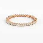 Rose gold bracelet with clear gemstones on a white background