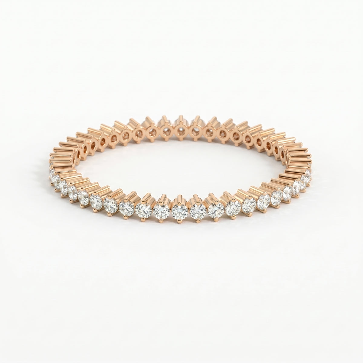 Rose gold bracelet with clear gemstones on a white background