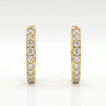 Yellow gold diamond huggie hoop earrings displayed in premium jewelry gift box for luxury gifting presentation