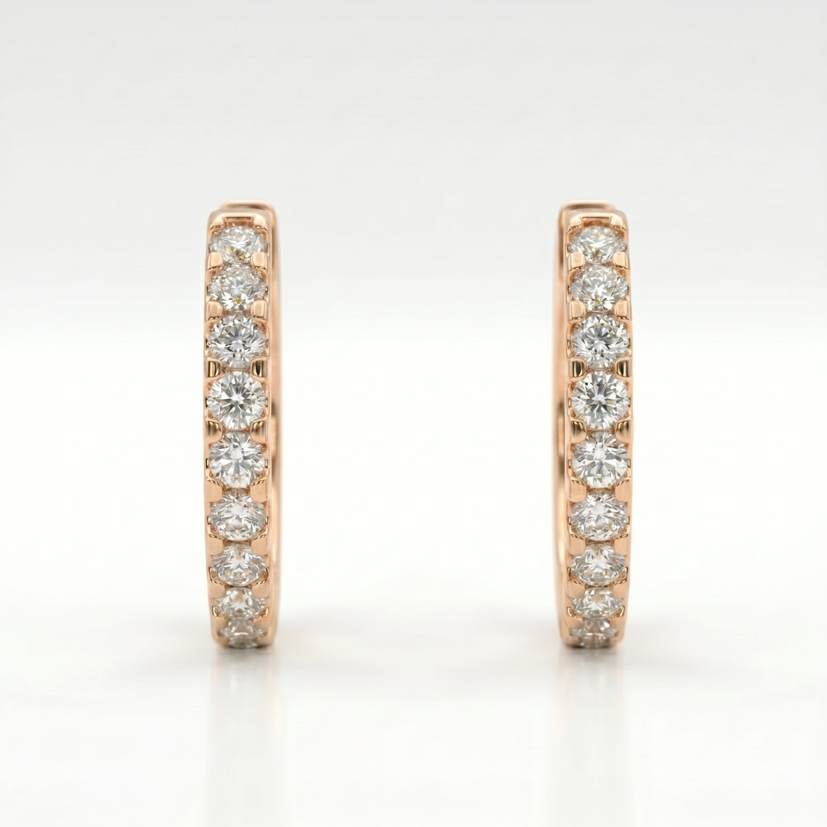 Rose gold diamond huggie hoop earrings with pavé-set round diamonds on clean white background