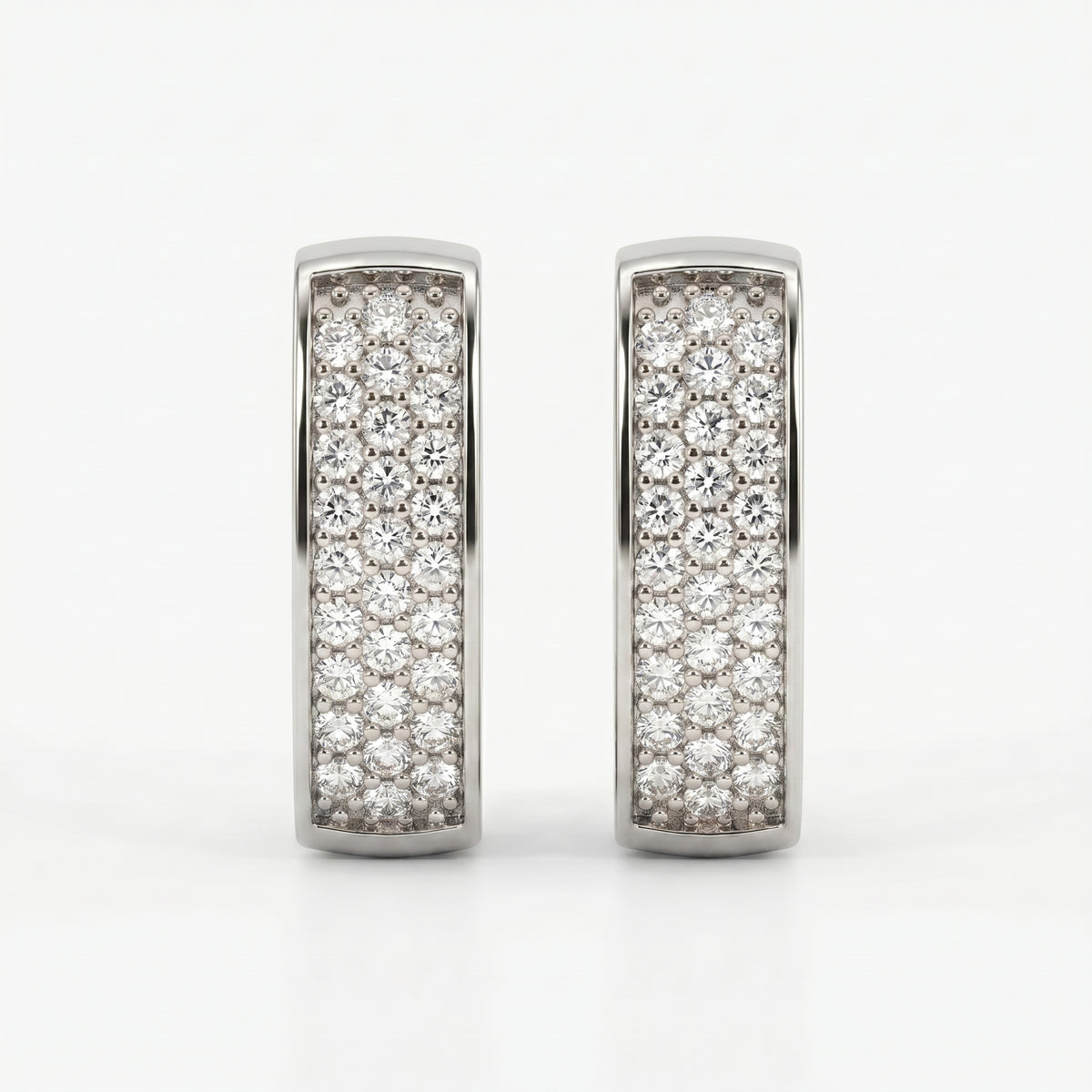 Macro close-up of pavé-set diamonds on White gold huggie earrings with brilliant sparkle and fine detail