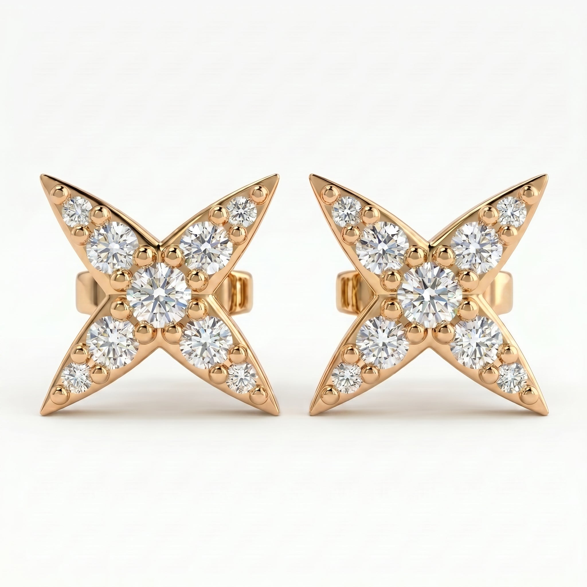 Luxury diamond star stud earrings at 45 degree angle showing pavé detailing and polished gold craftsmanship