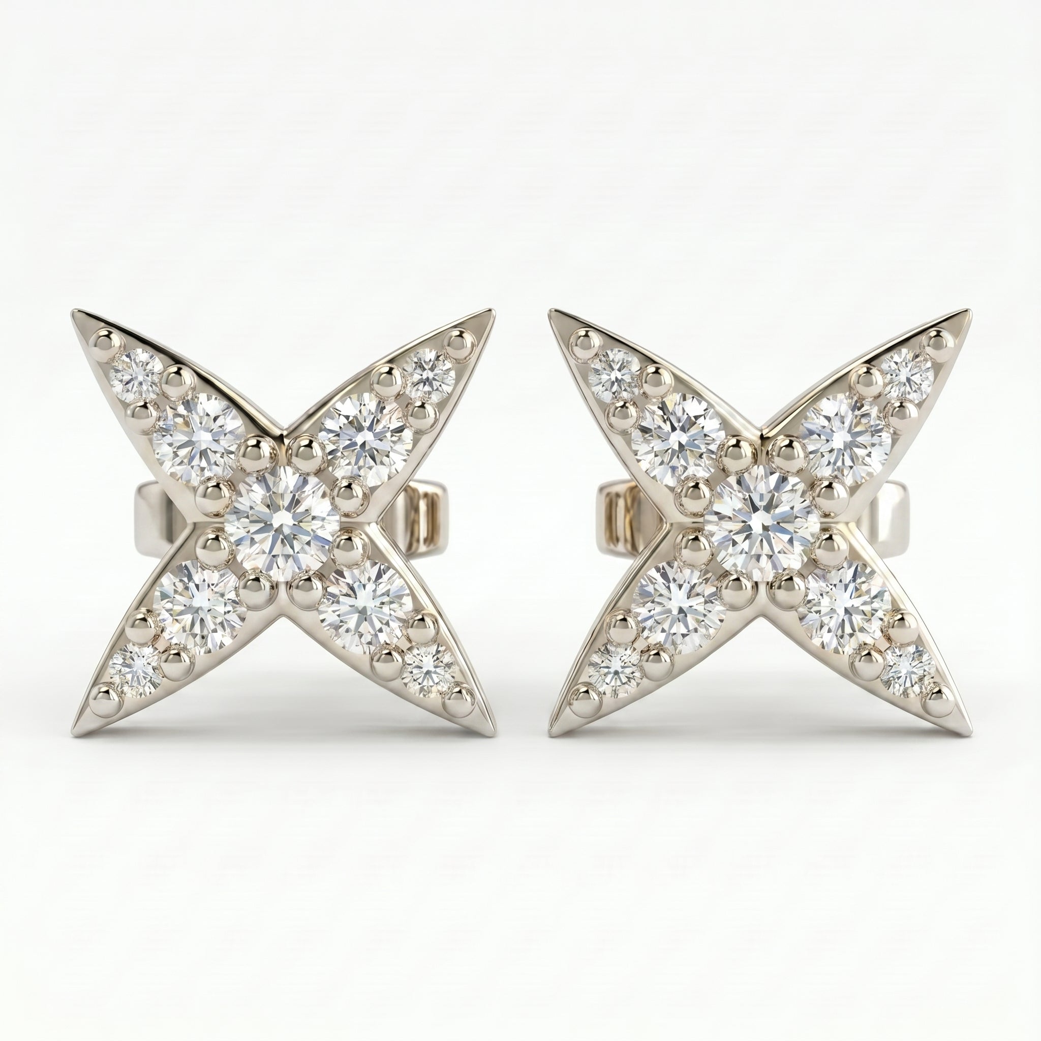 White gold diamond star stud earrings with pavé round diamonds on clean white background for luxury jewelry styling