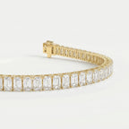 45-degree view of yellow gold emerald cut diamond tennis bracelet showing elegant craftsmanship and sparkle.