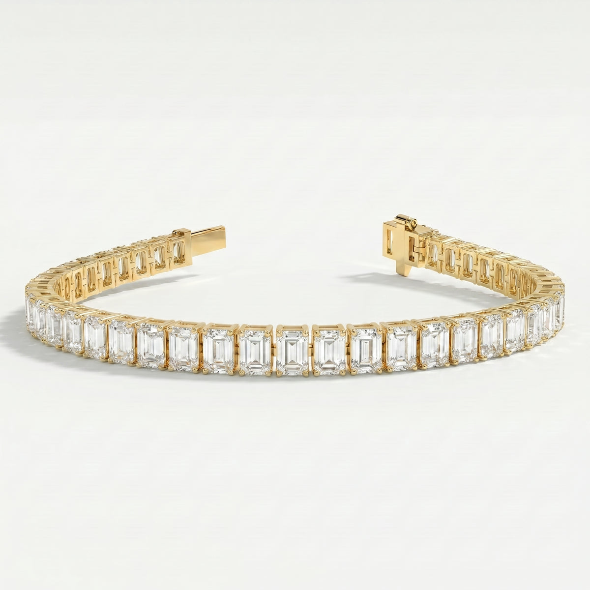 Side profile of emerald cut diamond tennis bracelet displaying yellow gold prong setting and craftsmanship.