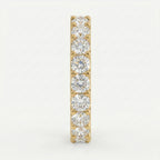 Gold earring with clear gemstones on a light gray background