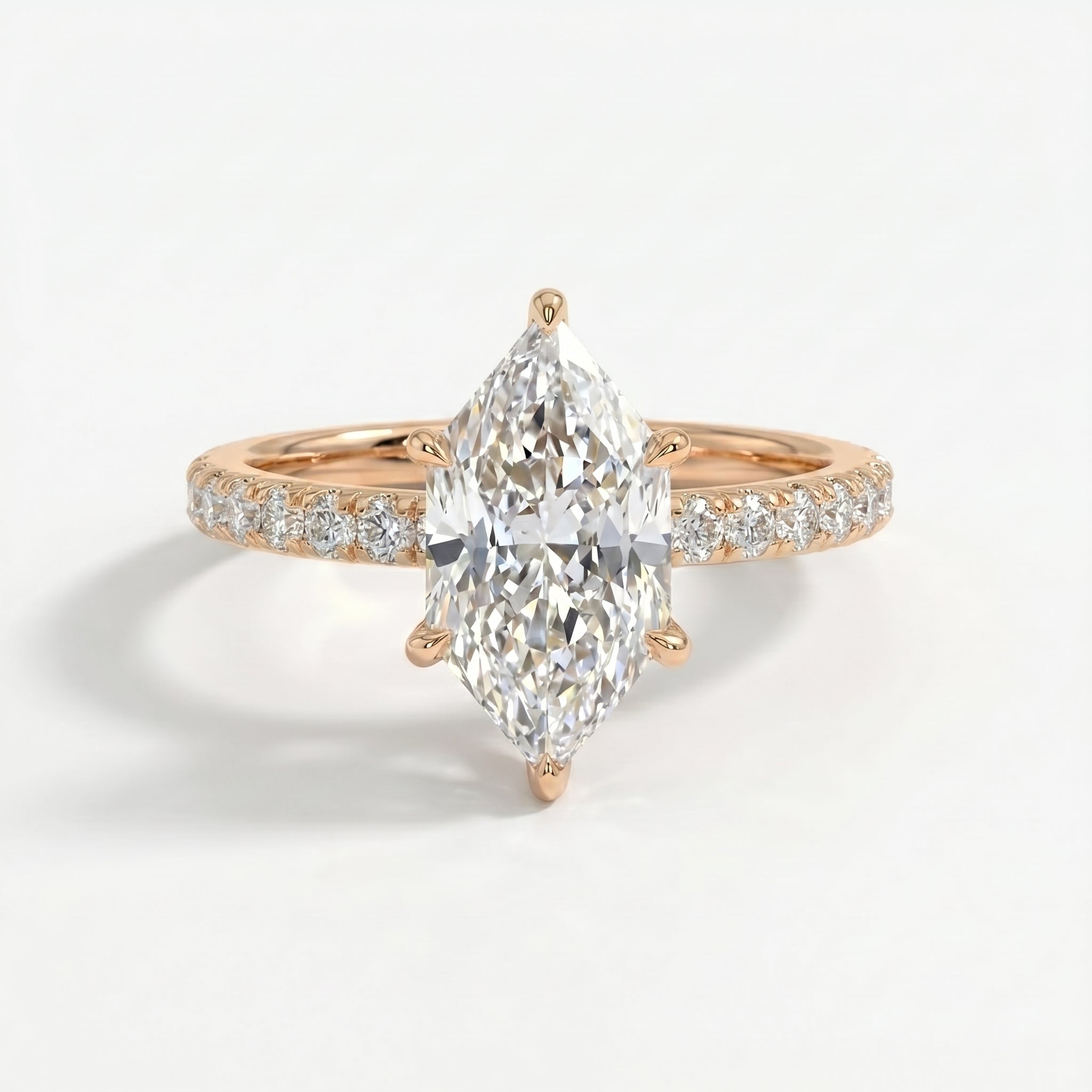 Marquise cut diamond engagement ring with pavé diamond band in rose gold, luxury bridal jewelry front view