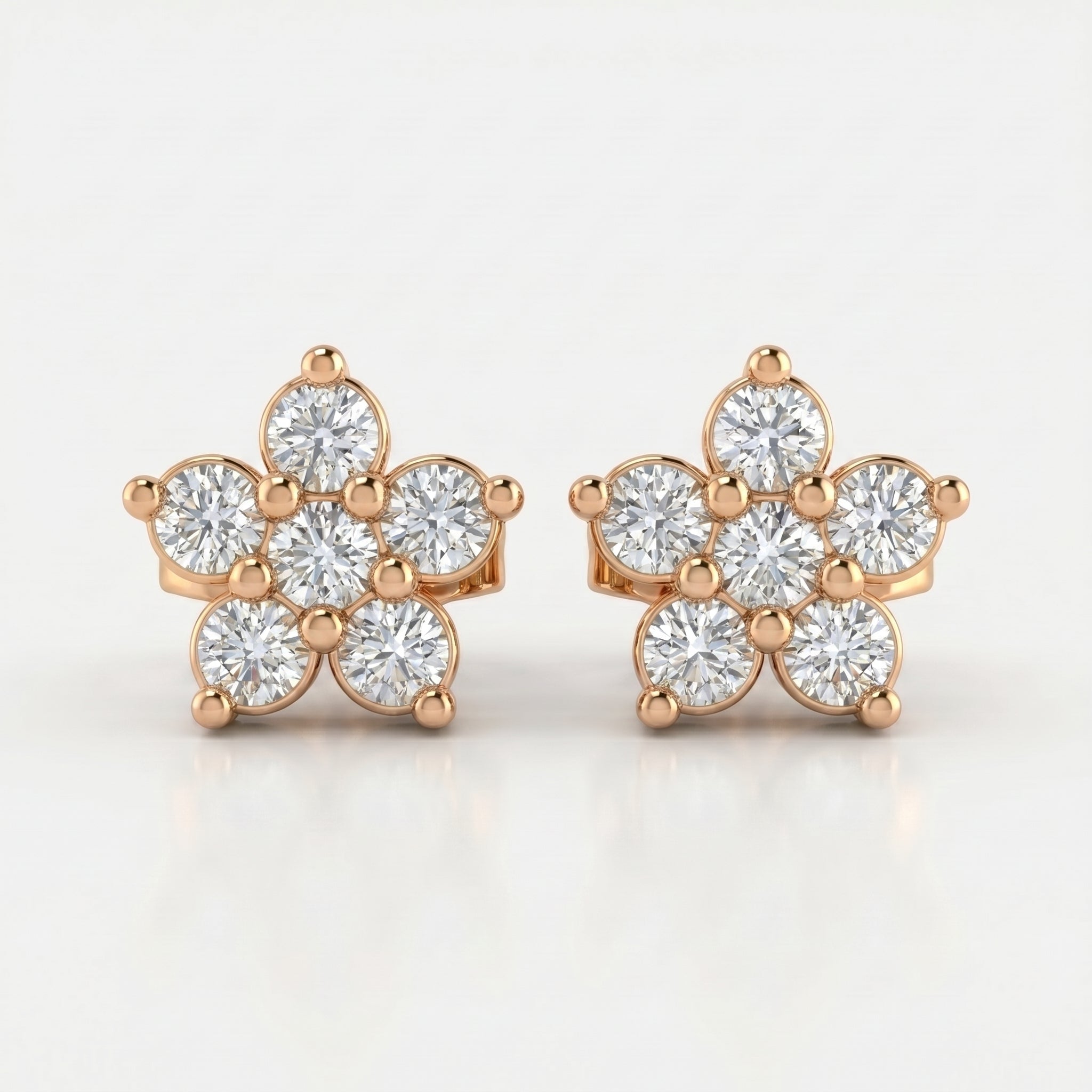 Rose gold floral diamond stud earrings with brilliant round stones on clean white luxury jewelry background