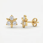 Woman wearing Yellow gold floral stud earrings with sparkling stones in elegant minimalist lifestyle setting