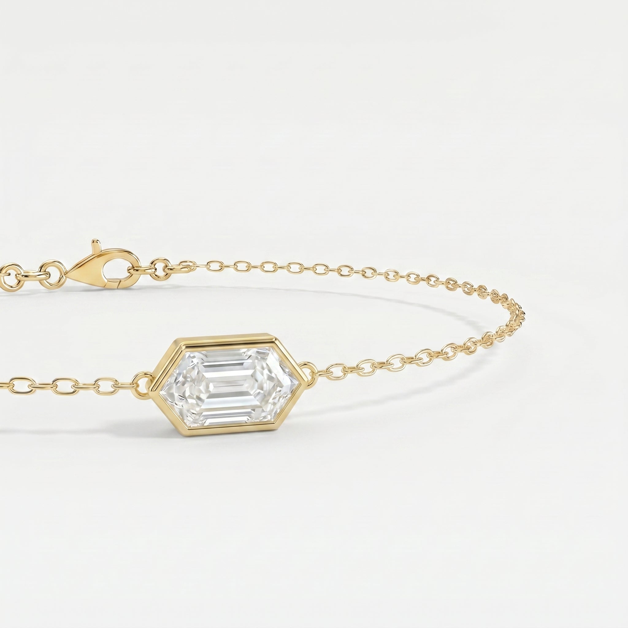 Luxury gold bracelet featuring hexagon-cut diamond style gemstone with delicate chain detail