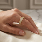 Yellow gold pavé diamond band ring with multi-row sparkling stones on a clean white background
