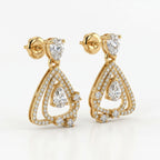 Yellow gold geometric drop earrings with pear-cut diamonds shown from a 45-degree angle highlighting craftsmanship