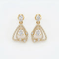 Luxury yellow gold pear drop diamond earrings with pavé detailing and geometric open-frame design on white background