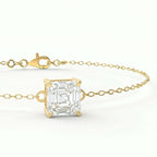 Luxury gold solitaire bracelet with Asscher-cut gemstone shown in elegant 45-degree studio angle