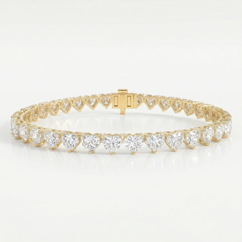 Luxury yellow gold heart diamond tennis bracelet with brilliant heart-cut stones and secure clasp on white background