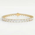 Luxury yellow gold heart diamond tennis bracelet with brilliant heart-cut stones and secure clasp on white background