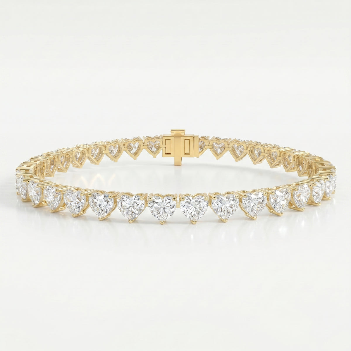 Luxury yellow gold heart diamond tennis bracelet with brilliant heart-cut stones and secure clasp on white background