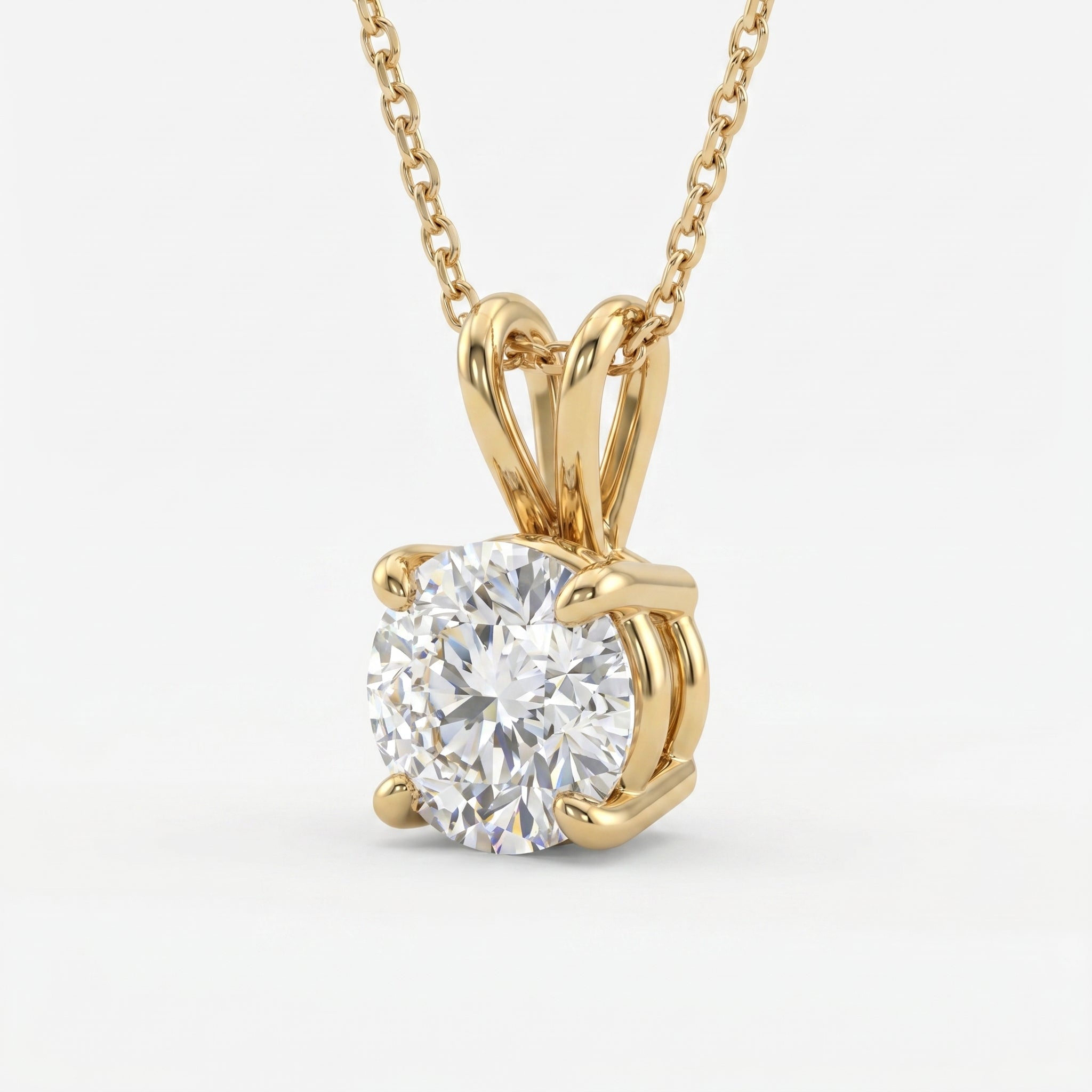 Gold necklace with a round diamond pendant on a white background