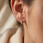 Luxury pavé huggie earrings presented in elegant jewelry gift box with premium sparkle and gold finish