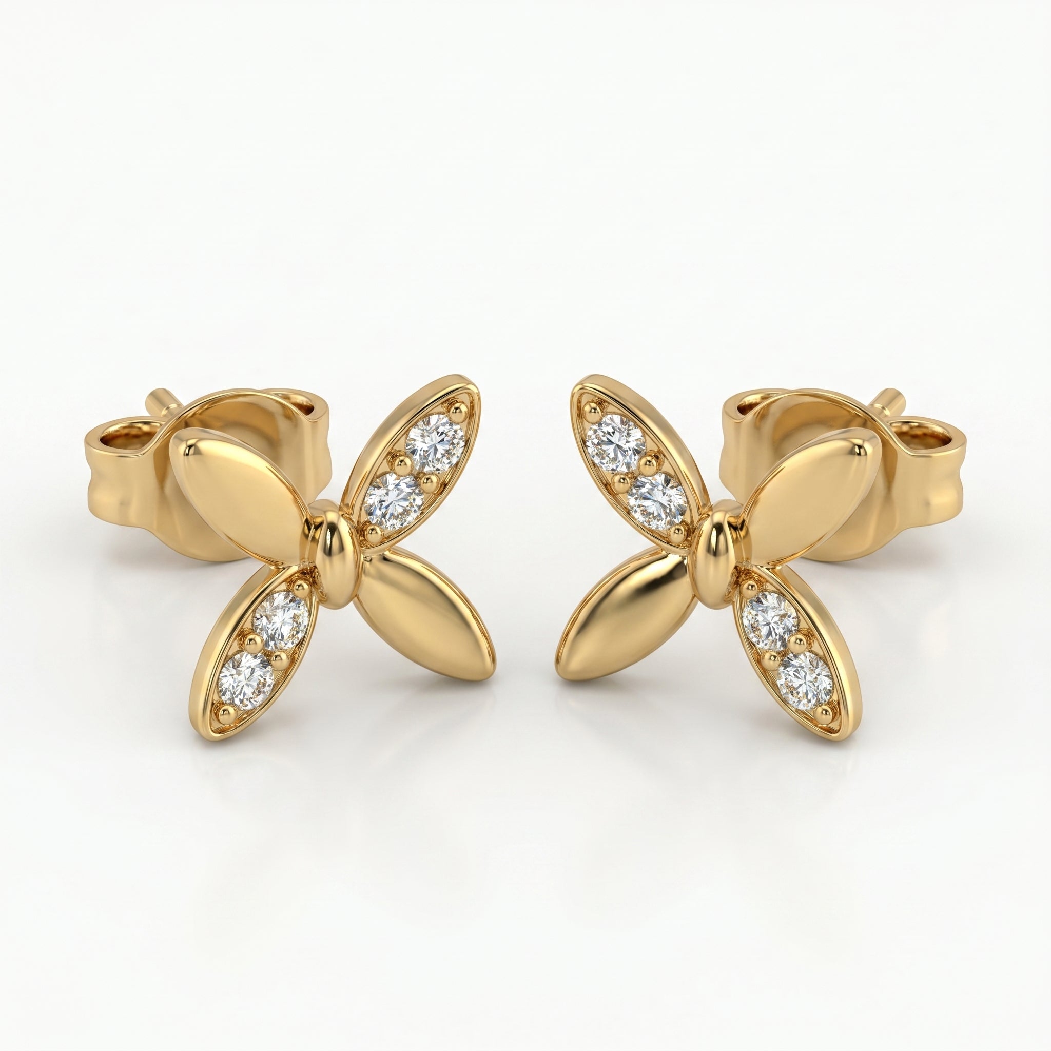 Macro close-up of pavé diamonds on butterfly stud earrings with high-polish luxury gold finish