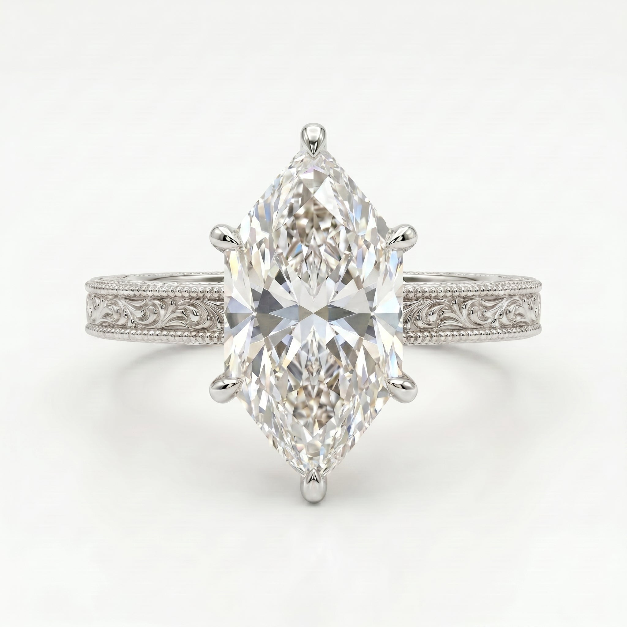 Marquise cut diamond engagement ring in white gold with vintage engraved band and six-prong solitaire setting.