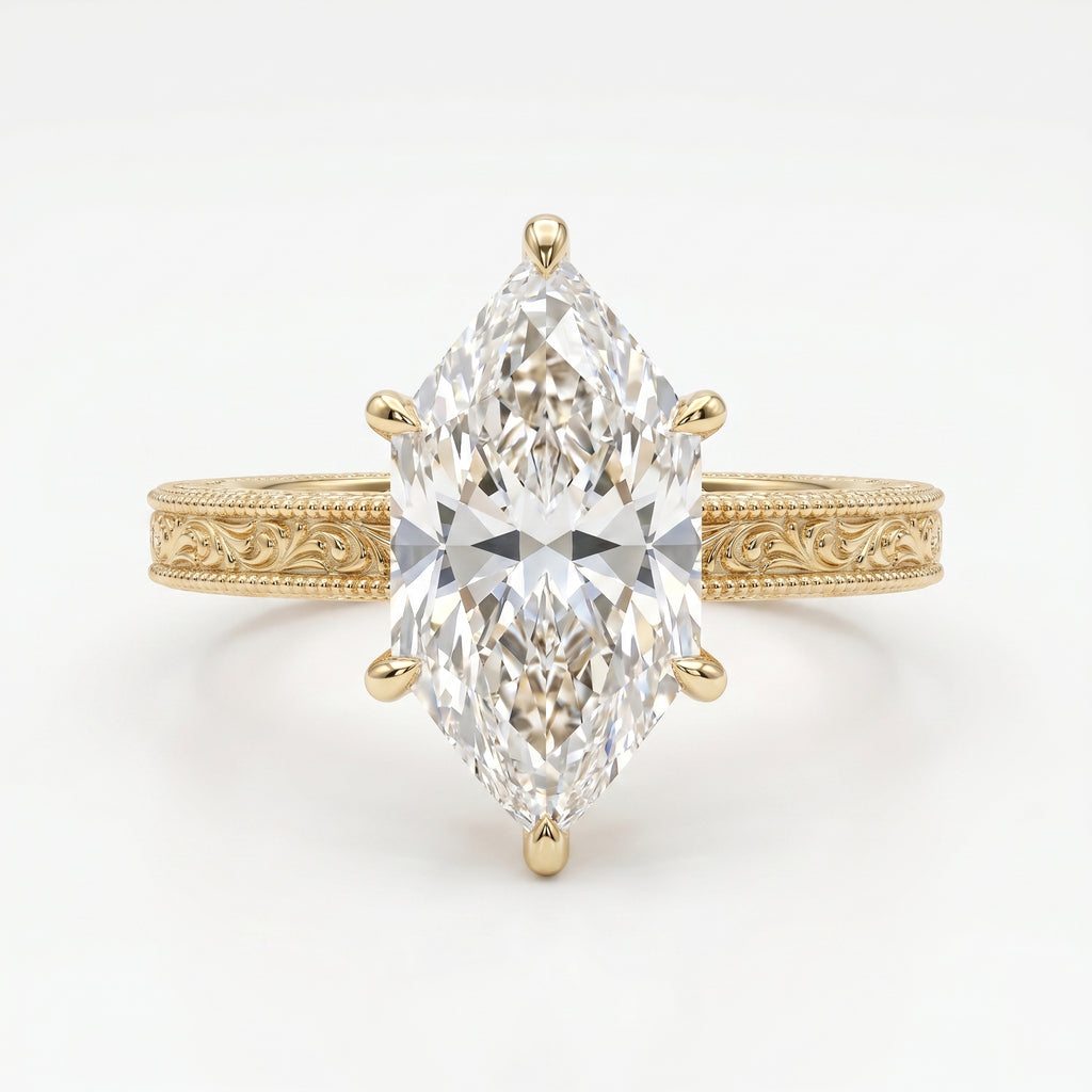 Yellow gold marquise cut diamond engagement ring with detailed milgrain engraving and elegant solitaire design.