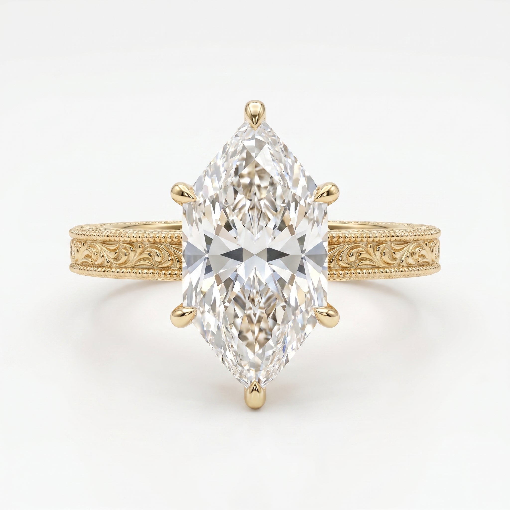 Yellow gold marquise cut diamond engagement ring with detailed milgrain engraving and elegant solitaire design.