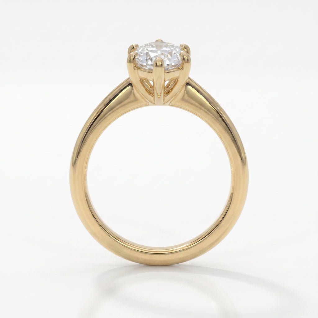 Front view of marquise cut diamond ring featuring baguette diamond accents in polished yellow gold