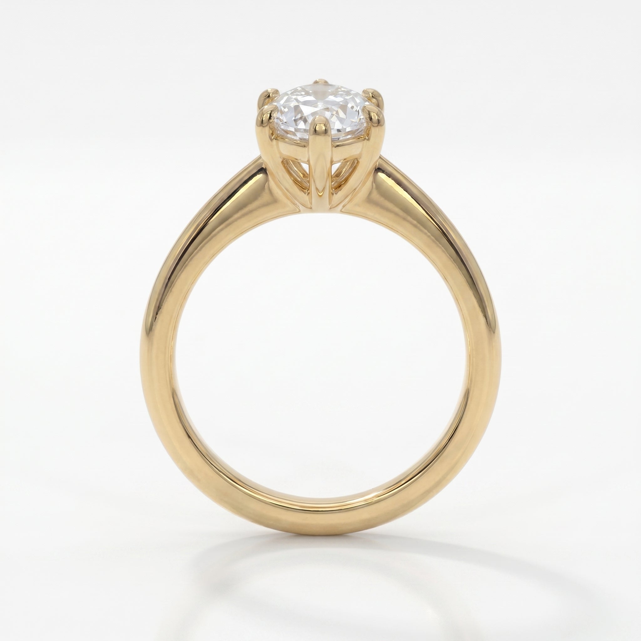 Front view of marquise cut diamond ring featuring baguette diamond accents in polished yellow gold