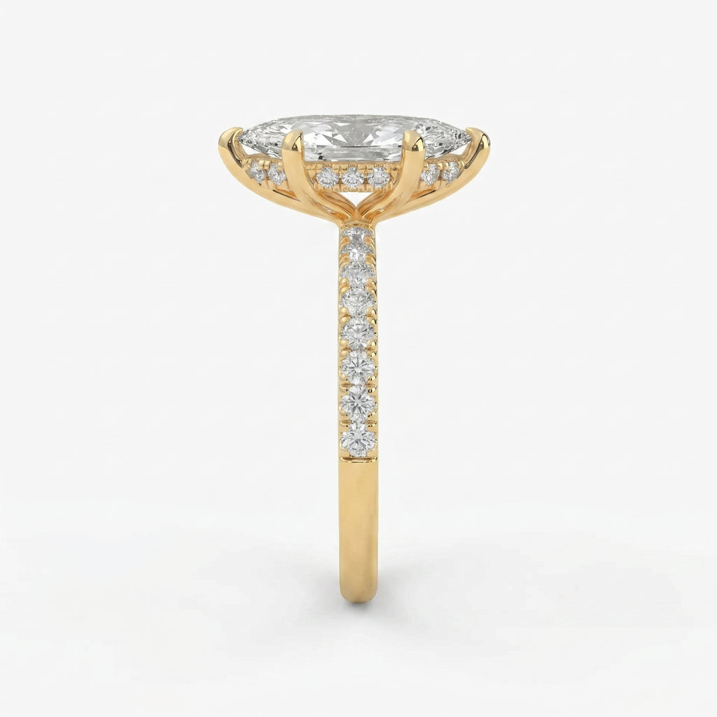 Side profile of marquise diamond engagement ring featuring cathedral setting hidden diamonds and yellow gold band
