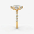 Side profile of marquise diamond engagement ring featuring cathedral setting hidden diamonds and yellow gold band