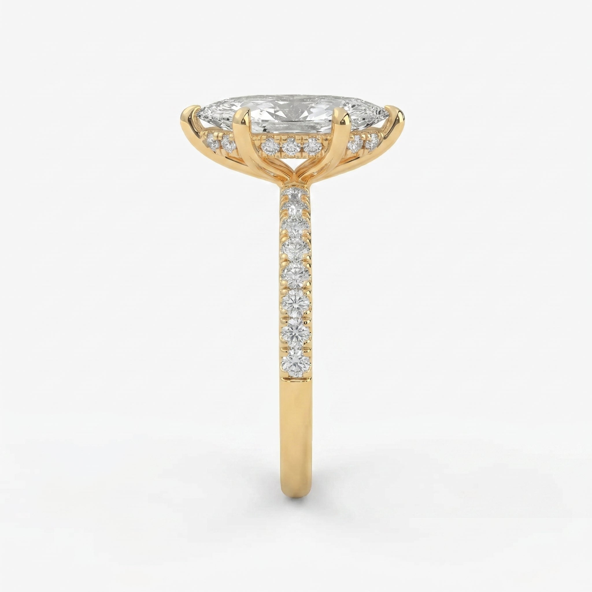 Side profile of marquise diamond engagement ring featuring cathedral setting hidden diamonds and yellow gold band