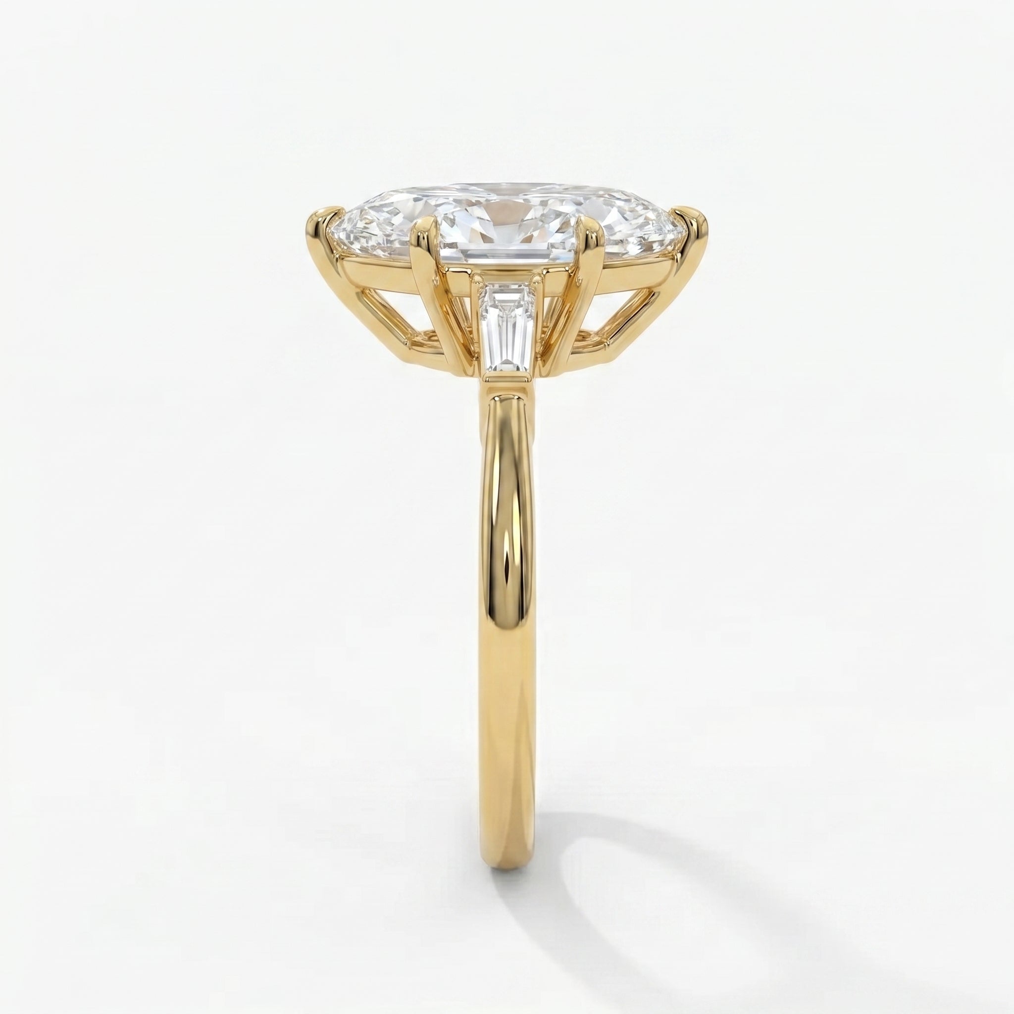 Side profile of marquise diamond engagement ring highlighting elevated basket setting and gold craftsmanship
