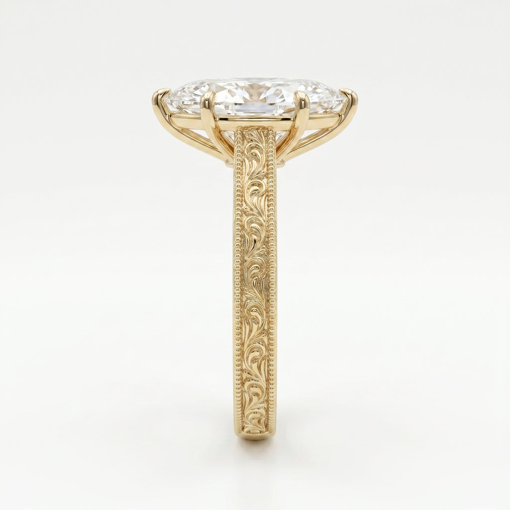 Side profile of marquise diamond engagement ring showing elevated setting and detailed gold engraving